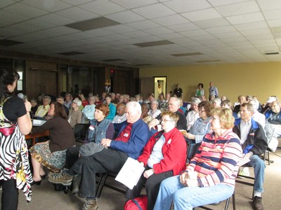 Attendees enjoying a guest speaker at a monthly Senior Social and Health Talk