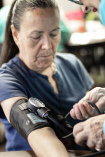 Nurse checking patient's blood pressure